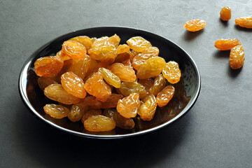 Big yellow raisins on a dark background