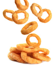 Fried onion rings falling on white background