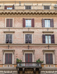 Fototapeta na wymiar vintage brickwall building facade windows pattern, Rome Italy