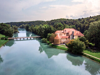 Fototapeta na wymiar Castle Otočec. Five star hotel and restaurant in Otocec castle, Slovenia. Beautiful Otocec castle in the forest on the island in the middle of the river.