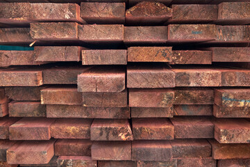 red wooden boards in a heap. rough surface texture