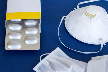 Medical face masks N95 on blue surface with medicine box