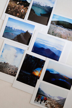 Some landscape polaroid photo laid out on a table.