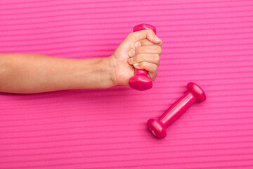 Girls use pink dumbbells for hand strength