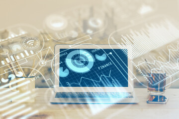 Computer on desktop in office with technology theme hologram. Multi exposure. Tech concept.