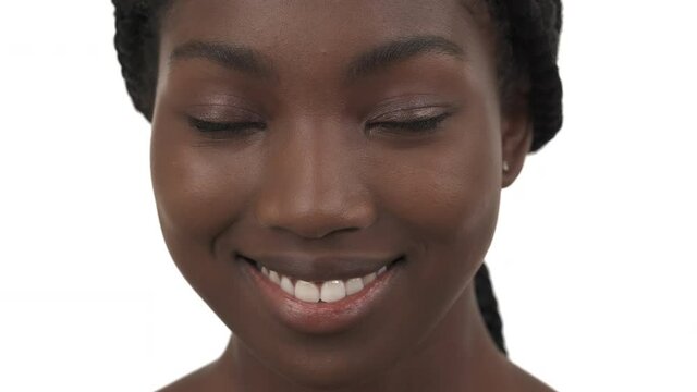 Close-up portrait of young African American girl with plump lips sending air kiss to camera. Isolated on white background