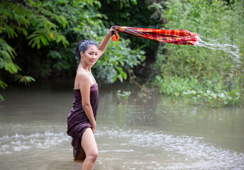 young Asian woman bathing in the river