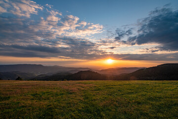 A sunset viewed from a mountain in the national park Black Forest in Germany, near Oppenau /...