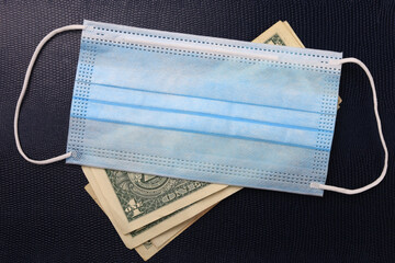Medical surgical mask and petty dollars. Background