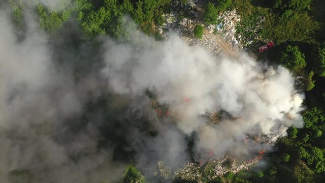Aerial top down view from fire at garbage dump, 4k