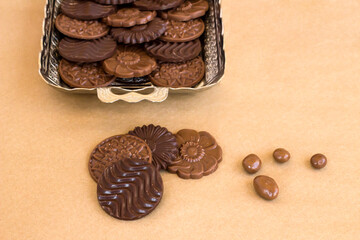 Madlen chocolate designed  in vintage silver tray on kraft paper background with ball chocolates,close up taken.
