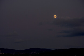 Dark evening landscape with shining full moon. Shining full moon on the sky.