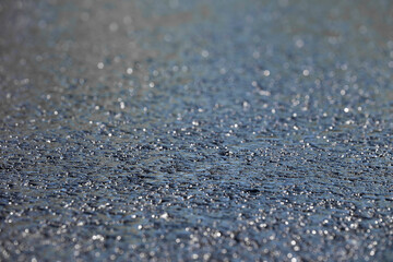 Fototapeta na wymiar Wet asphalt background texture. Shallow depth of field