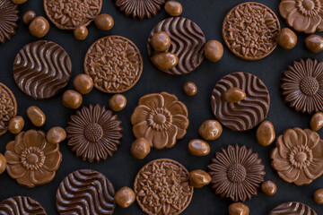 Milky and bitter round shape chocolate Madlen,designed on black background with dark ball chocolates.The Sugar Feast or any festival celebration.Top view.