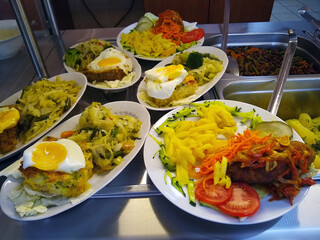 hot dishes on oval plates served in a public dining room