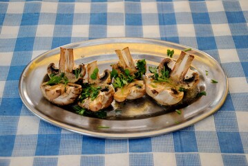 Grilled button or  champignon mushrooms (Agaricus) served with parsley in Cyprus