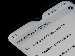 Browsing for tourist visa for Canada in mobile internet.