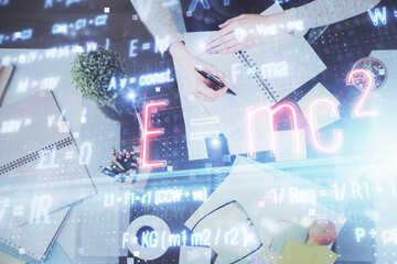 Science formula hologram over woman's hands taking notes background. Concept of study. Multi...