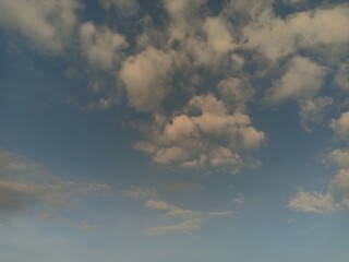 white clouds against a blue sky background