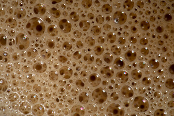 coffee in a cup with foam and bubbles.