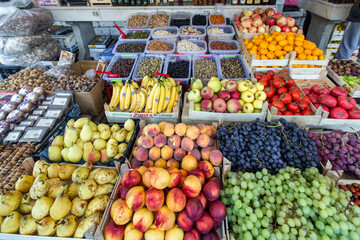 Fototapeta na wymiar Street market counter with various colorful fresh fruits and vegetables. Fresh friuts and vegetables in plastic boxes