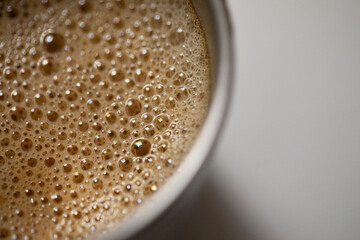 coffee in a cup with foam and bubbles.