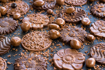Milky and bitter round shape chocolate Madlen,designed on black background with ball chocolate and grains.
