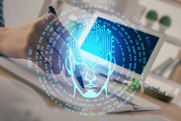 Multi exposure of writing hand on background with brain hologram. Concept of self learning.