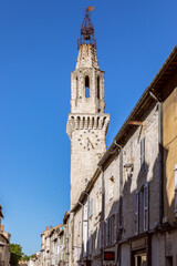 The central street with one of the towers of the city of Avignon leading to the papal castle