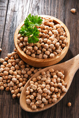 Composition with bowl of chickpeas on wooden table
