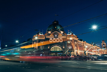 Fototapeta premium Heritage train station with tram passing in front of it 
