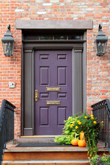 Violet vintage entry door decorated with columns and molding. New York. USA.