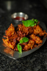 Crispy kanda pakora or kanda bhaji. Mumbai's road side snack. Favourite monsoon snack in India.