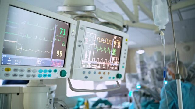 Monitors in intensive care unit. Heart beat of a patient on the screen of computers during operation in the hospital. Healthcare concept.