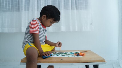 Cute little asian boy paint watercolor
