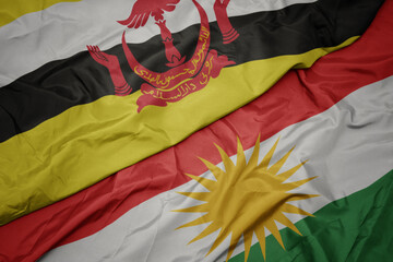 waving colorful flag of kurdistan and national flag of brunei.