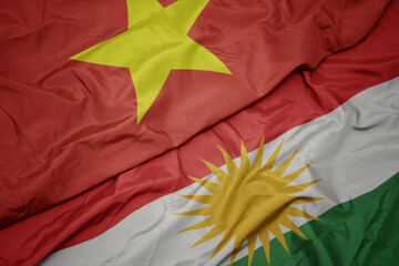 waving colorful flag of kurdistan and national flag of vietnam.