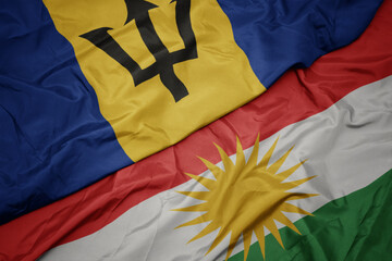 waving colorful flag of kurdistan and national flag of barbados.