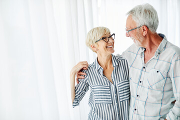 senior couple love together happy hug home family elderly man woman retirement smiling