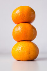 tower of three mandarines on white background