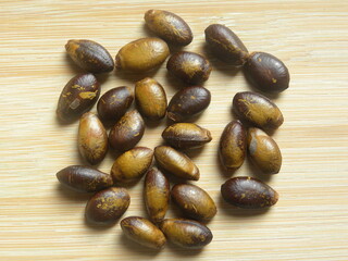 Brown and yellow color raw dried seeds of Soursop fruit or Annona muricata