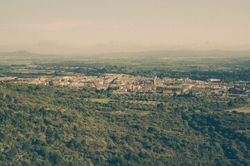 Vintage photography of a village in the middle of fields and olive trees
