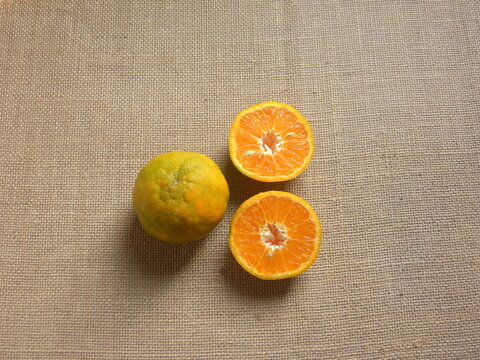 Whole and cut ripe Nagpur orange fruits