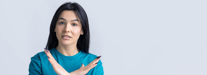 Girl disapproving with no crossing hands sign make negation gesture. Portrait of pretty woman on...