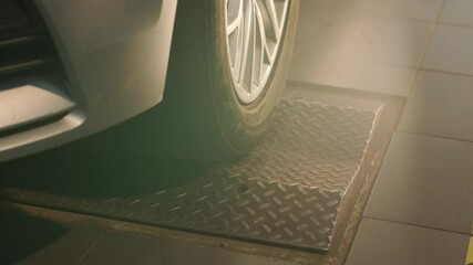 Car suspension test at automobile service. Inspection of the undercarriage of the car in the auto service. Repair and maintenance of the car in service.