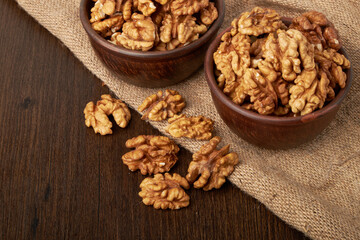 Walnut kernels on a wooden background.