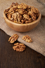 Walnut kernels on a wooden background.