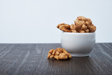 Walnut kernels on a wooden background.