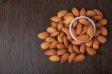 Walnut kernels on a wooden background.Almonds, walnuts and hazelnuts in bowls on a wooden background