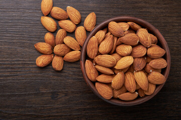 Walnut kernels on a wooden background.Almonds, walnuts and hazelnuts in bowls on a wooden background